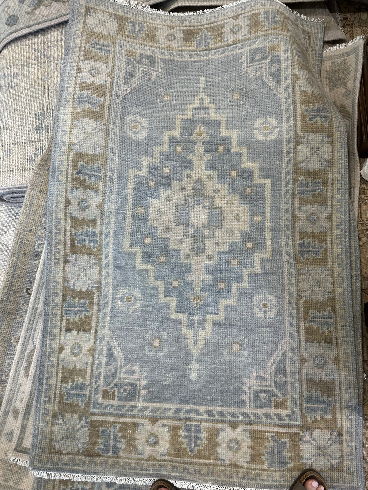 Susie hand-knotted wool modern Oushak rug, gray-blue base with warm brown border and olive and sage green