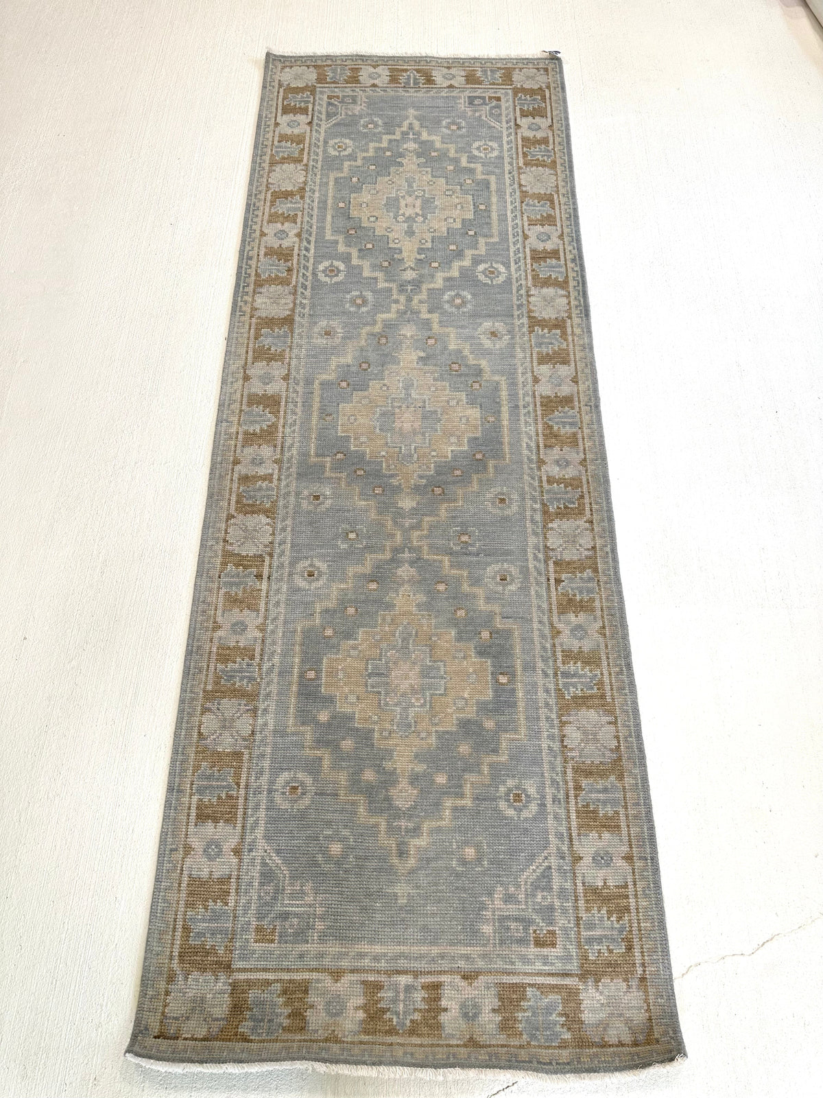Susie gray-blue and brown modern Oushak rug with sage green, tan, and cool gray accents, hand-knotted wool