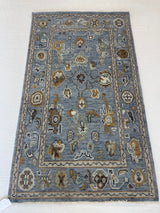Mae modern Oushak rug, hand-knotted wool with a blue-gray foundation and cream, mustard, sage, and brown accents