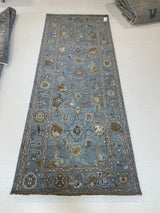 Mae modern Oushak rug, a blue-gray foundation and cream, mustard, sage, and brown accents