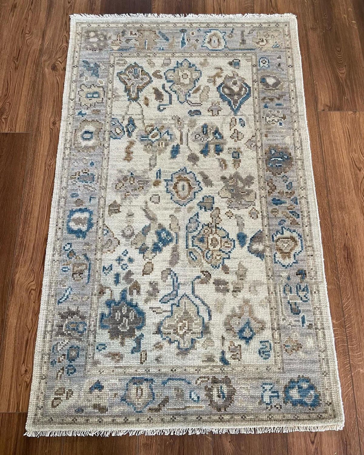 Ollie modern Oushak rug, cool gray foundation with taupe, cobalt blue, cream, and brown accents
