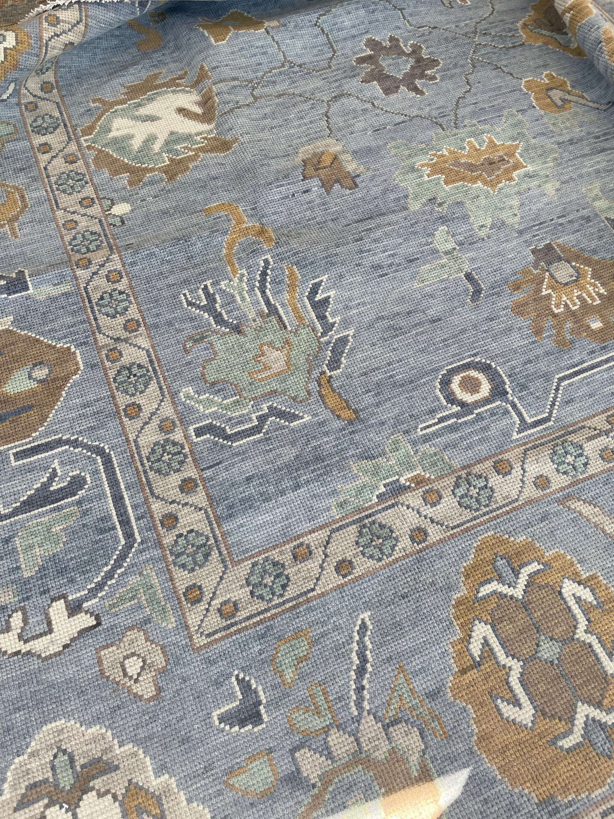 Mae modern Oushak rug with a blue-gray foundation and cream, mustard, sage, and brown accents, hand-knotted wool